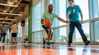 Man doing basketball drills with trainer