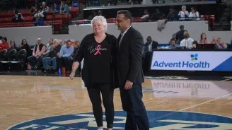 Man and woman on the center court at Lakeland Magic game.