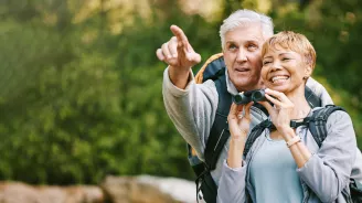 Older couple bird watching together.