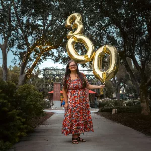 Jenn poses for a photo with balloons