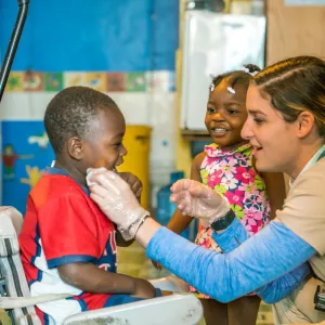 a healthcare worker examining a child