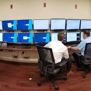 Doctors viewing 24 monitors inside of the Epilepsy Monitoring Unit at AdventHealth Tampa