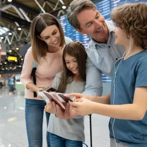 A family double checks their passports before an international flight.