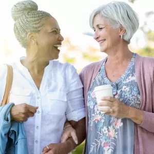 Two women walking and talking about their health.