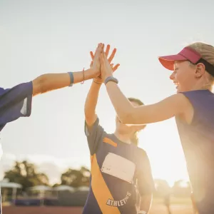 Young athletes high five after a good practice.