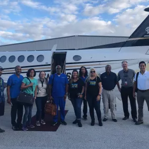 Bahamas recovery efforts team in front of airplane