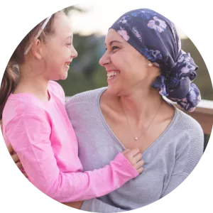 female cancer survivor holding daughter