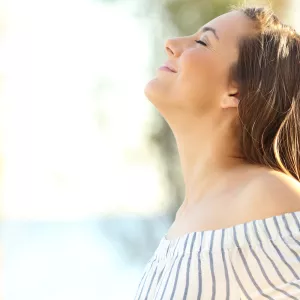 Happy woman breathing fresh air