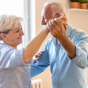 A couple dancing in the kitchen.