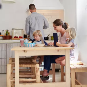 A young family sits around the table for breakfast