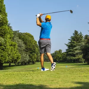 A golfer teeing off.