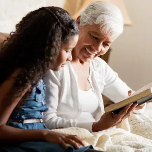 A grandmother and granddaughter read the Bible together.