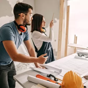 A young couple renovating a home. 