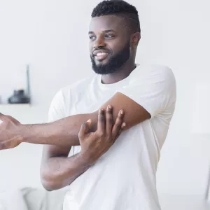 A man stretching at home.