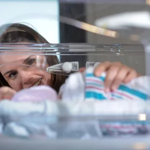 physician supervising a baby