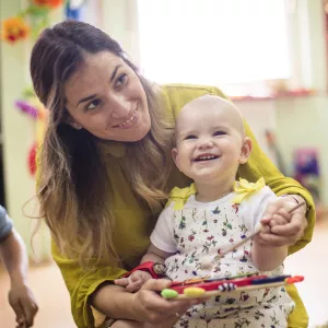 A young mom enjoys play time with her baby