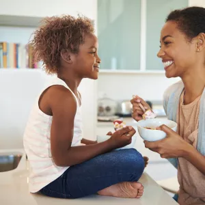 A mom and child eating a healthy breakfast together.