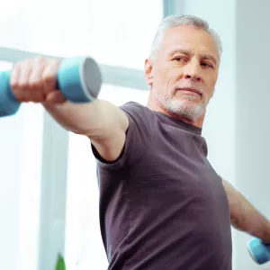 Man lifting weights at home.