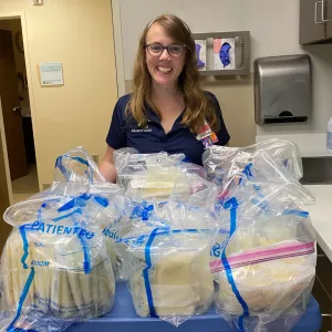 Laura Baran, a NICU nurse educator, with some of the breastmilk she donated.