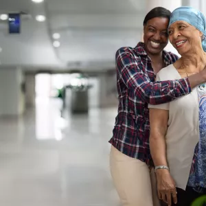 Cancer mom and daughter hugging