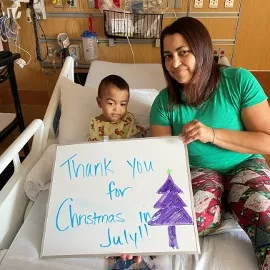 a patient and parent holding a thank you card