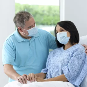 Patient with Family visitor in hospital bed