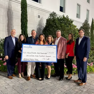 Group photo of check donation to AdventHealth Ocala