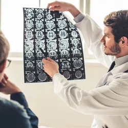 A doctor shows a patient a medical document. 