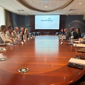 Pictured right leaning on the table: Abel Biri, AdventHealth Waterman CEO, emphasizes the hospital's dedication to quality care, community support and economic contributions in Lake County.