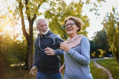 A Senior Couple Goes for a Run in a Park