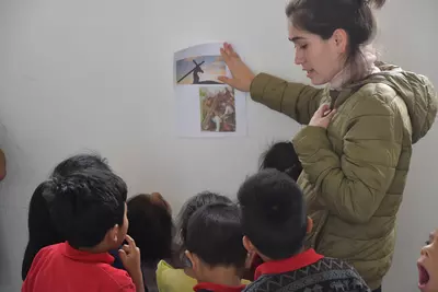 A teacher at the malnutrition center tells Bible stories to her kids.