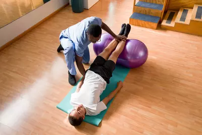 Physical Therapist working on stretching with patient
