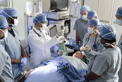 A group of surgical trainees conducting a mock surgery
