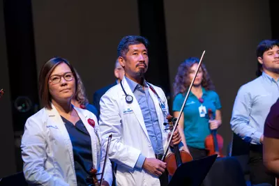 Grace Lai and Dr. Vincent Hsu with the AdventHealth employee orchestra.