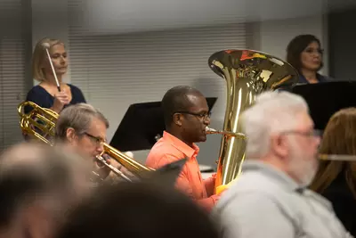 Paul Adeogun on the tuba practices with the AdventHealth employee orchestra.