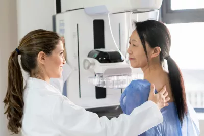 A woman about to receive a mammogram.