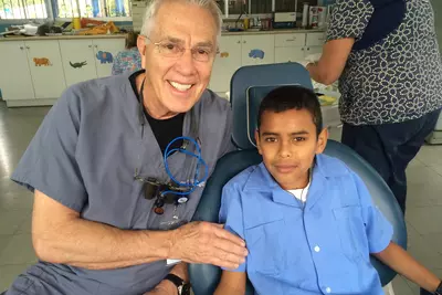 AdventHealth Sharing Smiles, Dentist with patient on mission trip.