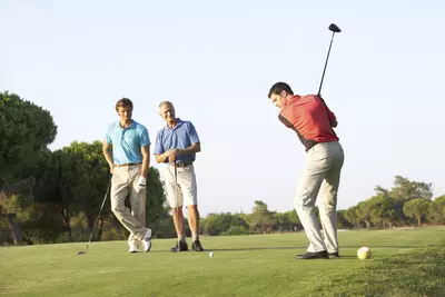 Three men golfing.