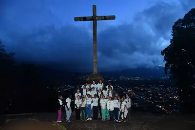 The group of AdventHealth volunteers gather in front of a cross above the city of Antigua, Guatemala.