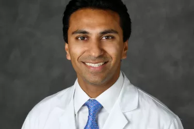 A professional headshot of Dr. Raj Martinez