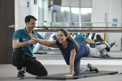 Physical therapist with patient doing stretches