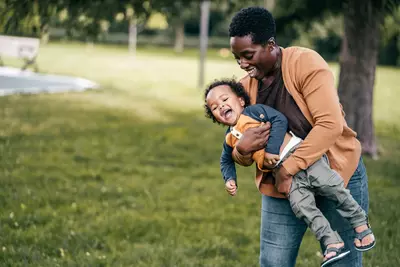 A mom and child playing outside. 