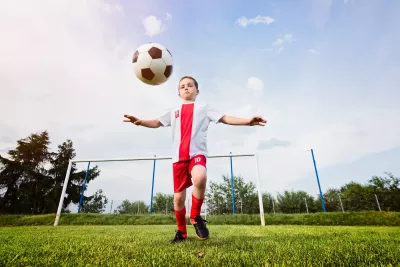 A young boy about to kick a soccer ball.