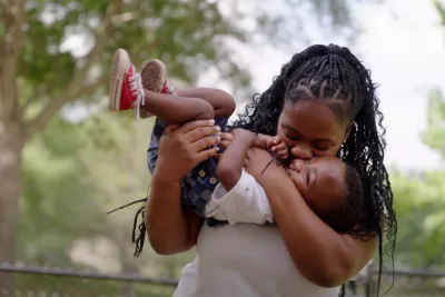 A woman holding her young son.