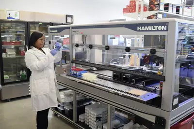 Female Laboratory Team Member Using Hamilton Robot