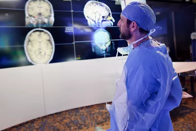 physician-looking-at-brain-scans