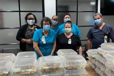 A group of health care workers with food donations