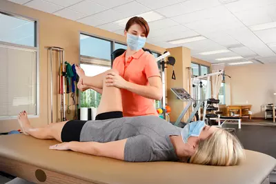 A woman getting physical therapy done by a female specialist