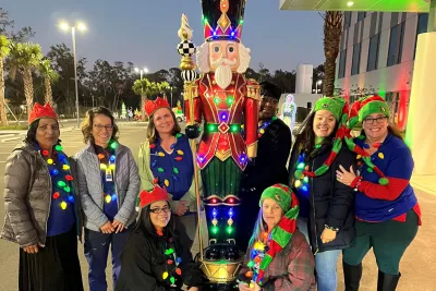 AdventHealth Riverview team members celebrate Lighting the Way, a drive through holiday event supporting ECHO.