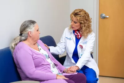 Dr. Sharona Ross comforting patient.